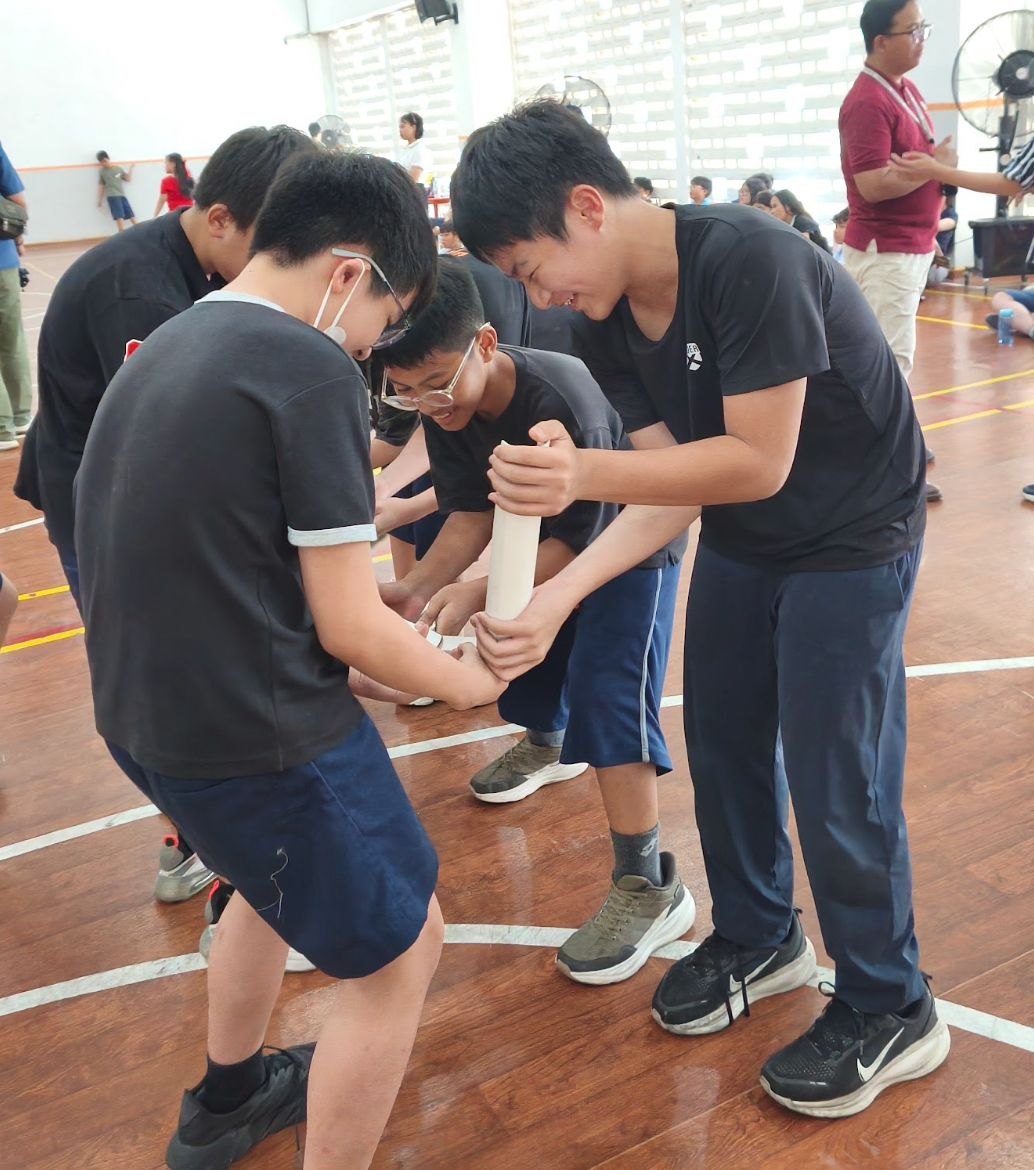Students working together in the school auditorium